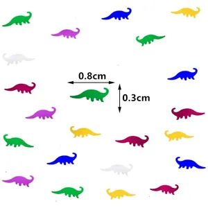 Colorful dinosaur party confetti for Jurassic themed birthday table decor