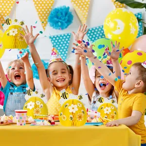 Bee honeycomb party decorations used in a lively children's birthday celebration scene