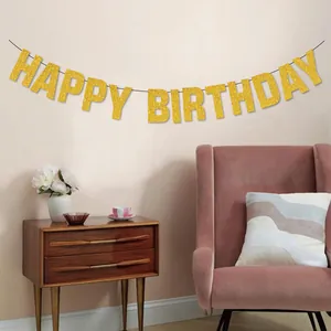 Elegant gold glitter Happy Birthday banner hanging in a cozy living room for party decor