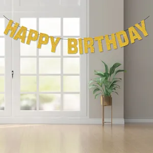 Gold glitter Happy Birthday banner for party decoration hanging in a bright room