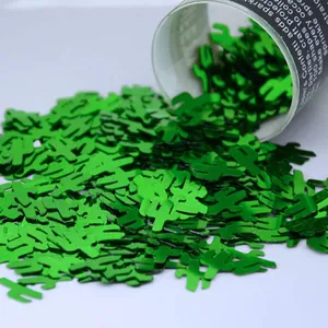 Close-up of sparkling green cactus-shaped confetti for Mexican theme party decorations