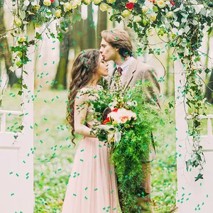 Green cactus shaped PVC confetti decorations scattered in a romantic forest wedding scene
