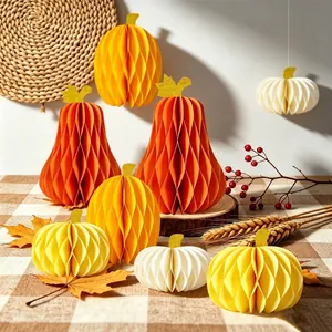 Set of multi-colored paper pumpkin honeycomb decorations for autumn party table decor