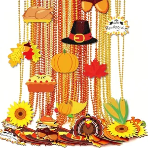 Close-up of Thanksgiving bead chains with pumpkin, turkey, and maple leaf charms