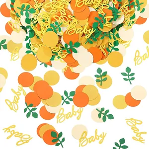 Detailed view of Baby Shower paper confetti decorations in autumn orange and gold glitter