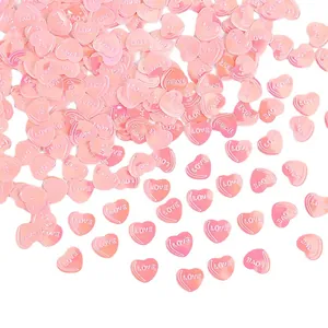 Rosa herzförmiges Konfetti mit LOVE-Schriftzug für die Dekoration zum Valentinstag.