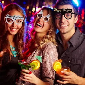 Detailed view of decorative New Year party paper glasses worn by people at a celebration.