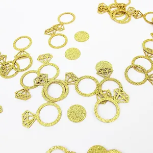 Detailed macro view of golden glitter diamond ring and circle confetti decorations