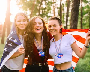 Tres mujeres con collares de cuentas patrióticos para el Día de la Independencia de EE. UU.