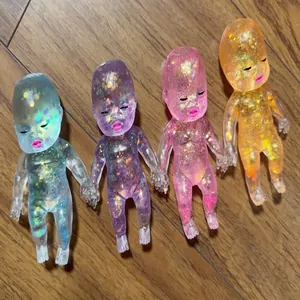 Glitter baby stress relief toys in four vibrant colors displayed on a wooden surface