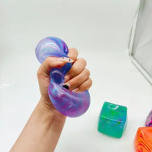 Close-up of a hand squeezing a purple marbled maltose squishy toy for stress relief