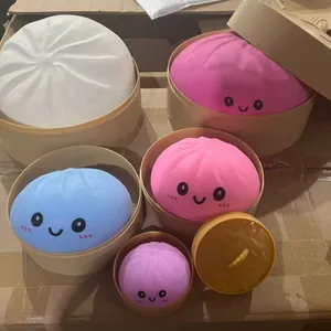 Detailed view of colorful dumpling-shaped squishy stress relief toys in mini steamers.
