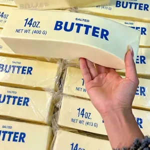 Detailed view of a salted butter stick squishy stress relief toy being squeezed