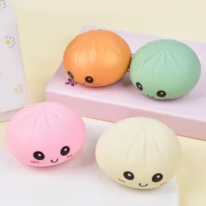 Close-up showing the soft texture and smiling faces of four colorful squishy buns