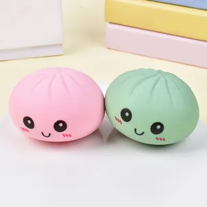 Macro view of cute pink and green smile face squishy steamed bun stress relief toys
