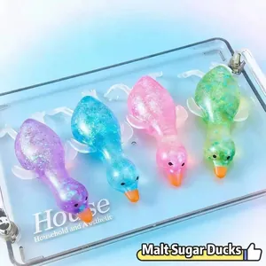 Detailed macro view of four colorful translucent glitter duck squeeze toys for stress relief