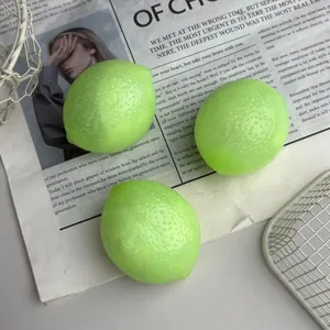 Close-up of three bright green simulation lemon squeeze toys on newspaper background