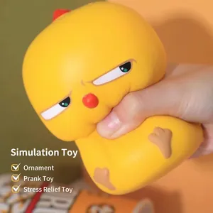 Close-up of a hand squeezing a yellow cartoon chicken slow rebound stress relief toy.