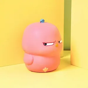 Close-up detail of a pink slow rebound squishy toy with a cute grumpy chicken face