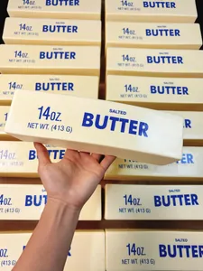 Detailed close-up of a slow rebound squishy salted butter stick toy held in hand.