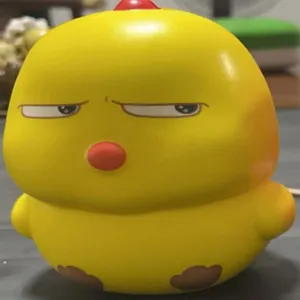 Close-up of a yellow cartoon chicken squishy toy with a funny skeptical expression.