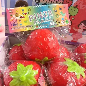 Giocattolo antistress a forma di fragola rossa con foglie verdi e confezione colorata vivace