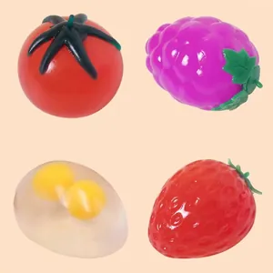 Detailed view of colorful fruit-shaped squishy toys including tomato and strawberry