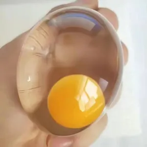 Close-up of a transparent egg squeeze toy with a yellow yolk for stress relief