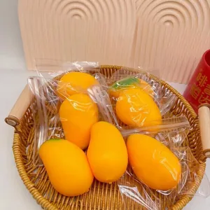Detailed shot of realistic mango-shaped fluid decompression toys in clear zip bags
