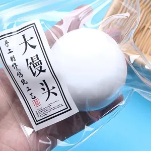 Soft white squishy steamed bun stress relief toy in clear plastic packaging for kids