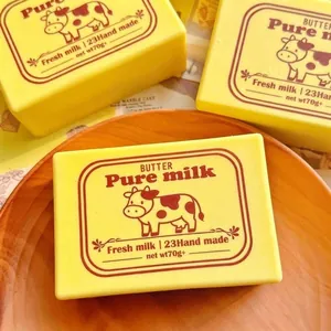 Soft yellow butter-shaped squishy toy for stress relief with a cute cow pattern