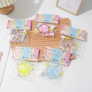 Collection of colorful crystal cat paw squishy toys in cute retail packaging on wood
