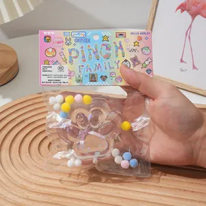 Detailed view of the soft crystal cat paw pinch toy inside its vibrant retail packaging.