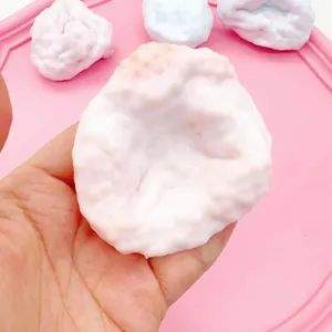 Macro detail of a milky white ice-skin squishy toy featuring a soft and elastic texture.