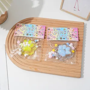 Detailed view of cat paw squeeze toys in colorful pinch family packaging