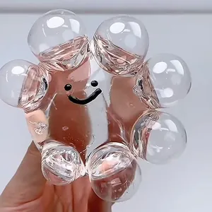 Detailed view of clear bubble stress relief toy with black smiley face design