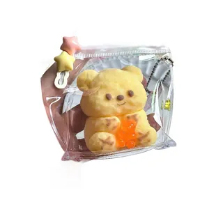 Cute yellow butter bear squishy toy in a clear bag with decorative star clips and chain