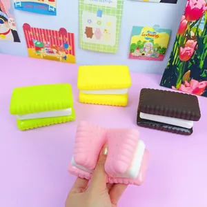 Macro shot of a pink macaron square biscuit squishy toy being squeezed for stress relief