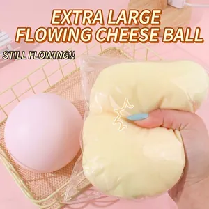 Detailed close-up view of a hand squeezing a jumbo fluid cheese squishy stress relief toy
