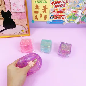 Hand squeezing a purple glitter ice cube squishy toy for effective stress relief