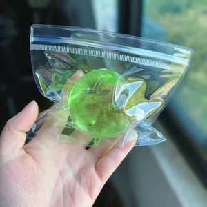 Vibrant green apple-shaped squishy stress relief toy held in clear plastic packaging