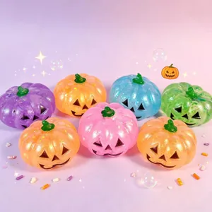 Colorful glitter Halloween pumpkin squishy stress relief toys with cute Jack-o'-lantern faces.