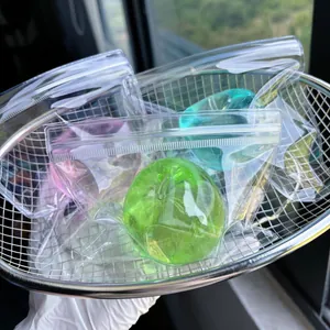 Colorful apple-shaped squishy toys in individual clear zip-lock bags for stress relief