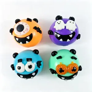 Macro view of four colorful Halloween-themed monster squeeze toys on white background.