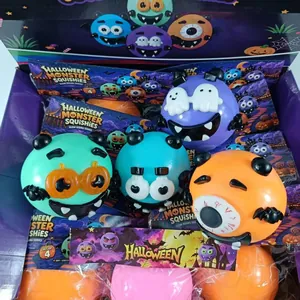 Close-up detail of colorful Halloween monster squishies with funny faces in a display box