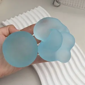Primo piano di giocattoli blu smerigliati e modellabili su un vassoio bianco ondulato.