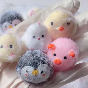 Macro view of cute fluffy animal squeeze toys showing soft texture and pastel colors