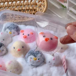 Close-up of various cute animal-shaped squeeze toys including penguins and pigs.