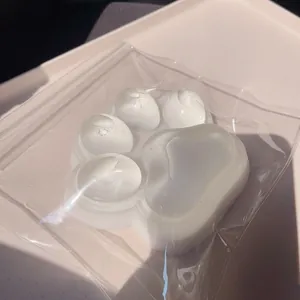 Primer plano de juguete antiestrés con forma de pata de gato blanco translúcido