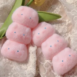 Detailed close-up shot of cute pink fluffy pig squishy toys on an elegant white lace background